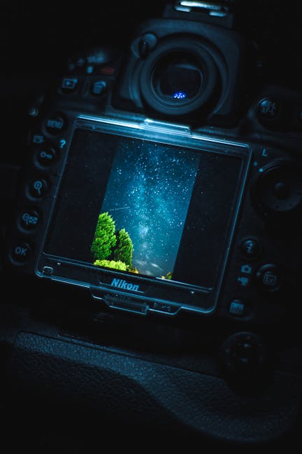 Close-up of a Nikon camera displaying a stunning starry night sky photograph.